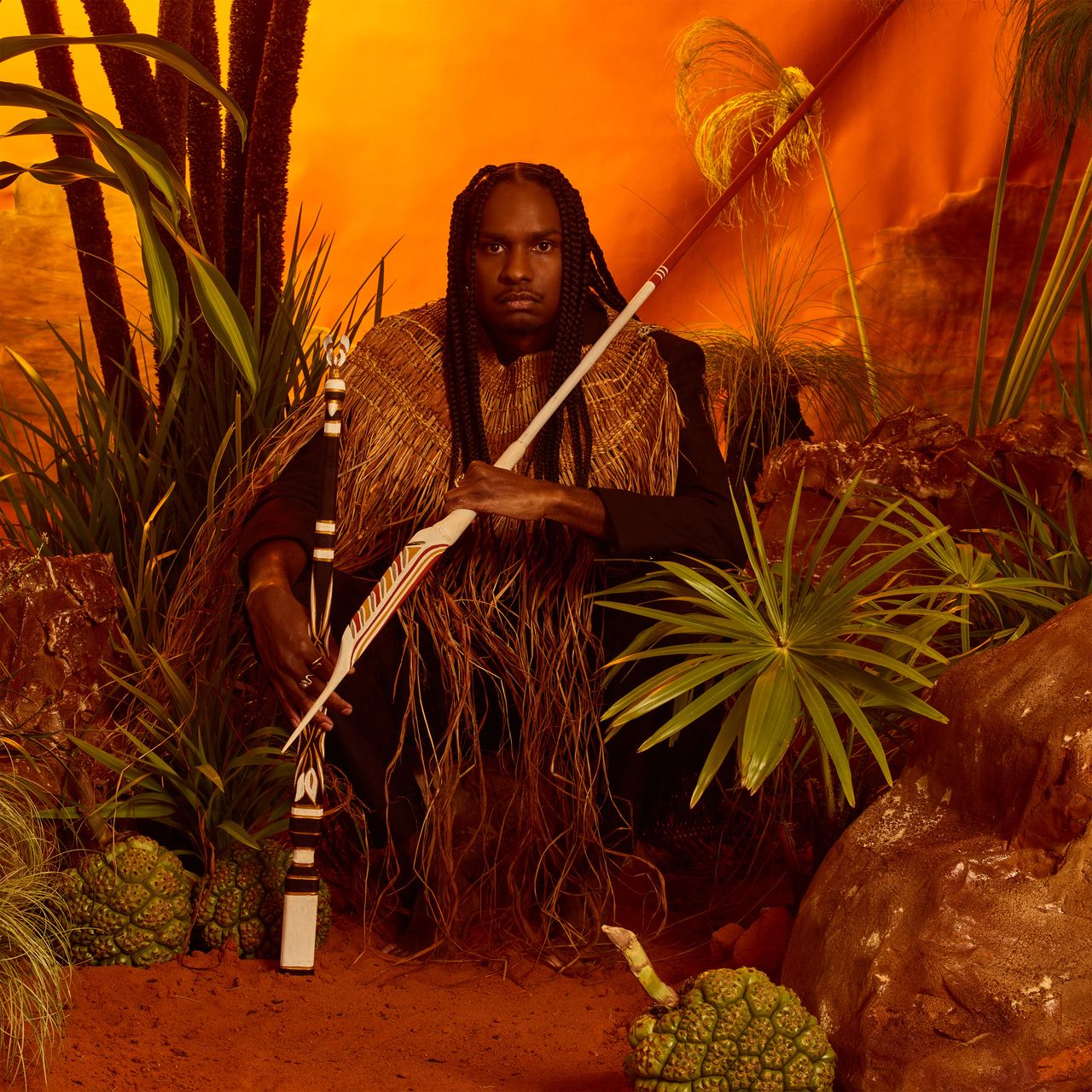 Album cover artwork for Baker Boy's DJANDJAY Deluxe edition, featuring the Indigenous artist holding traditional items in vibrant bush landscape.